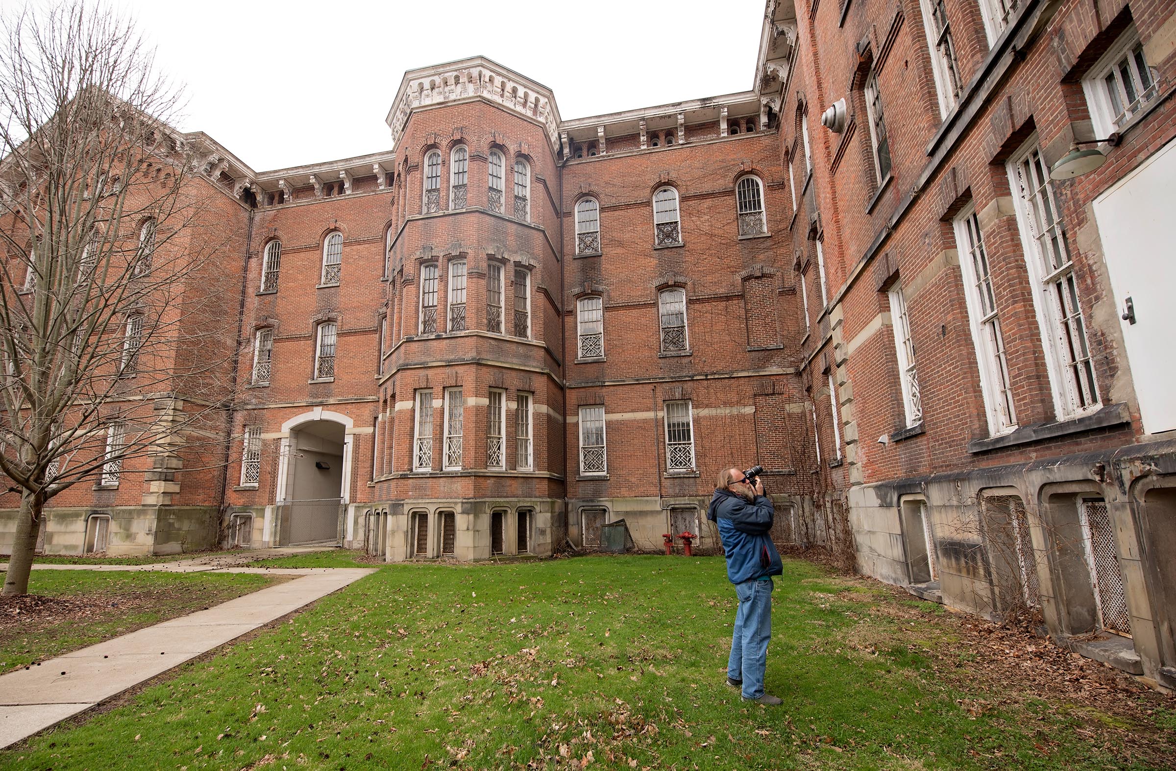 Pete Wuscher takes photos at The Ridges. The part of the building he is photographing is where he spent some time as a patient in the 1980's.