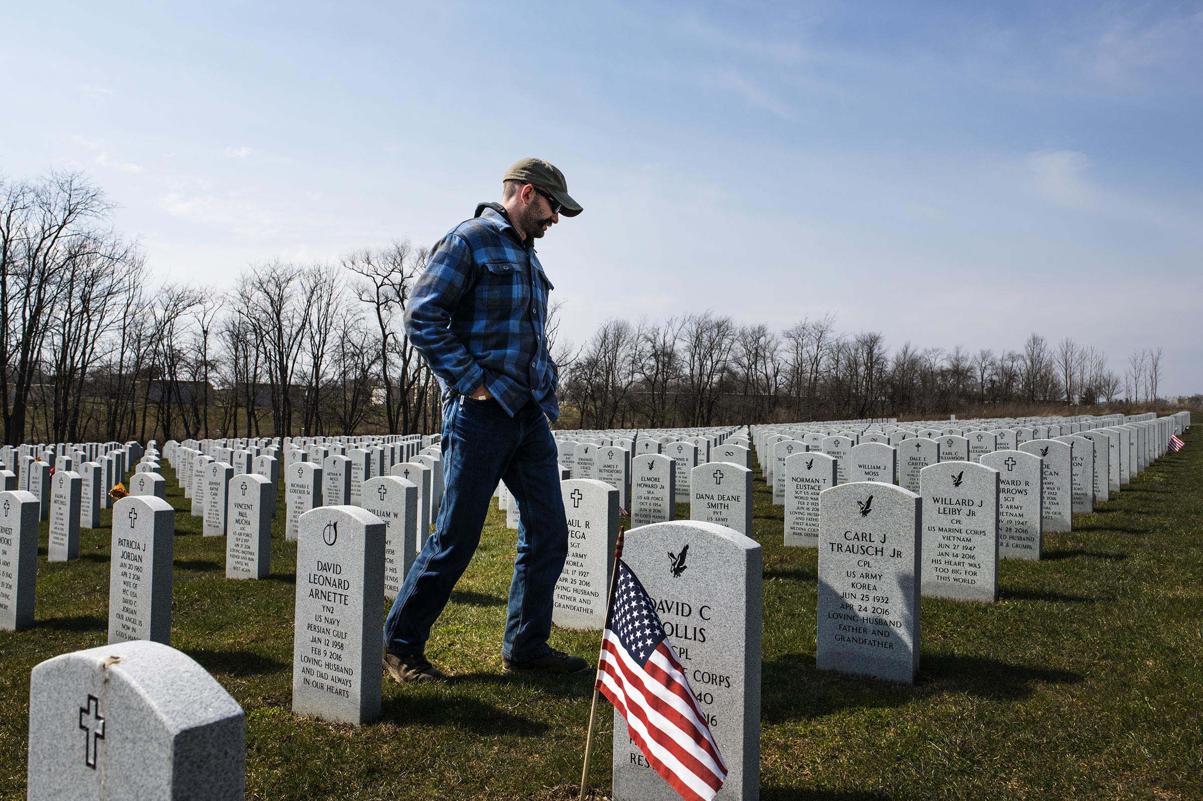  Adam walks through the Ohio Western Reserve National Cemetery in Seville, Ohio looking for his friend Coolhand's grave marker.
